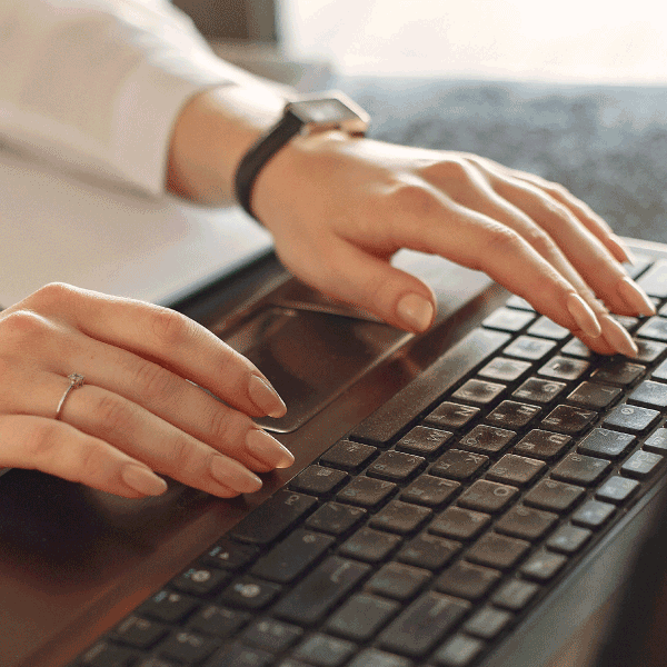 A woman typing on her laptop