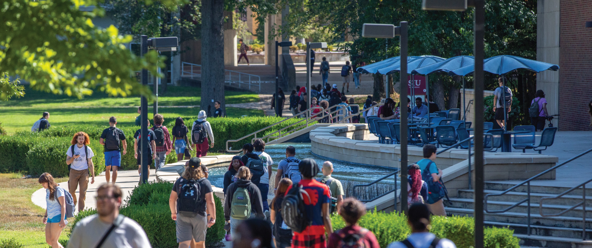 Many students walking past Morris Library on SIU's campus