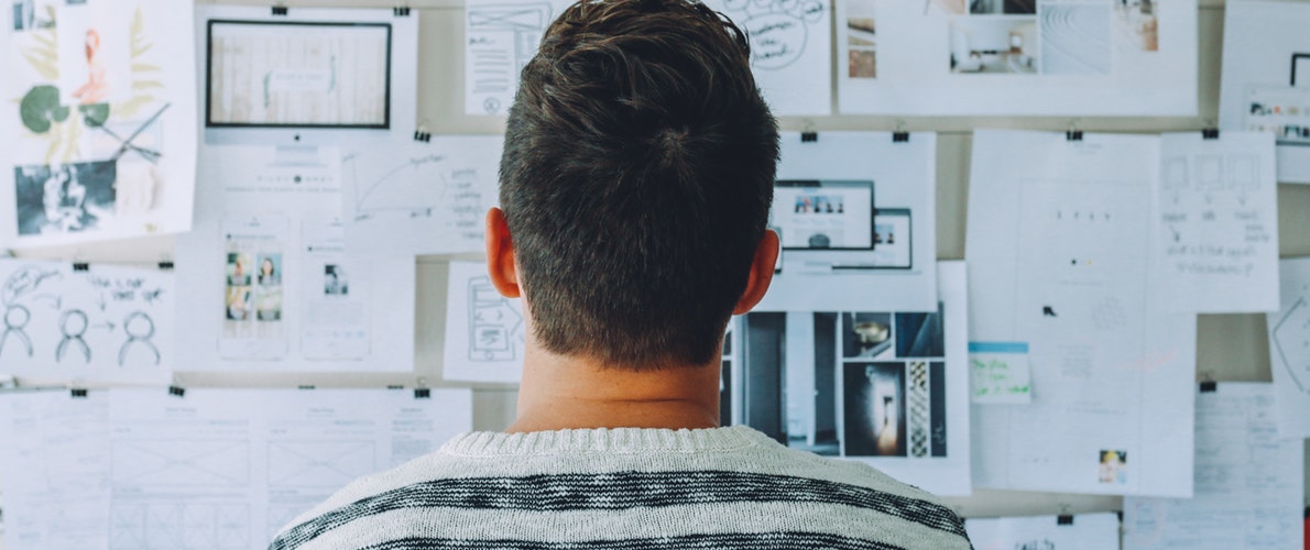 Man looking at a project board