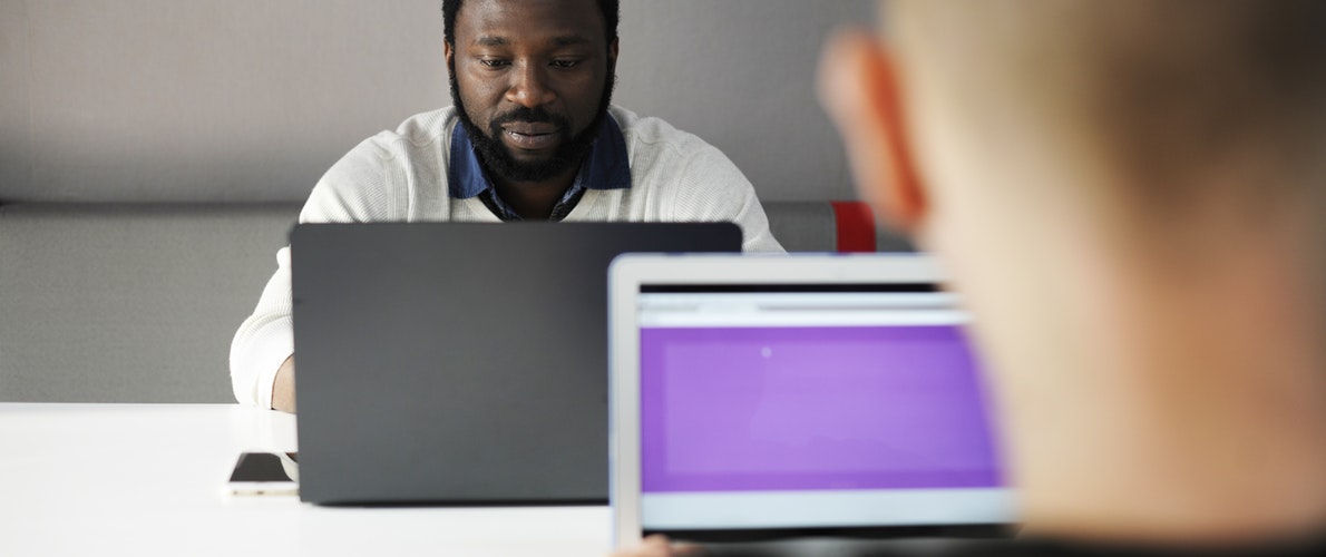 Two men on laptops